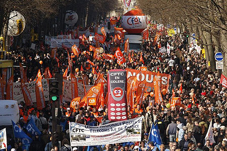 General view of public and private sector workers waving flags and banners as they attend a protest march in Paris on March 19, 2009.